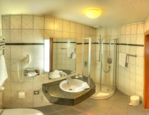 a bathroom with a sink and a shower at Boutiquehotel Liebesglück - adults only in Winterberg