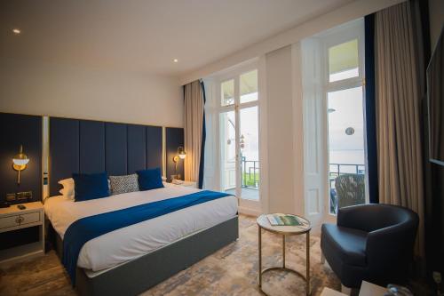 a hotel room with a bed and a chair at Dover Marina Hotel & Spa, Tapestry Collection by Hilton in Dover