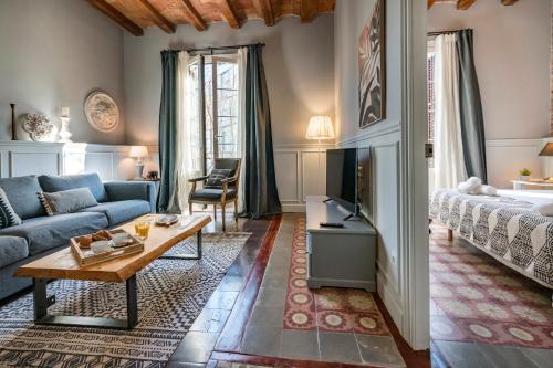 a living room with a couch and a tv at Habitat Apartments Alaia in Barcelona