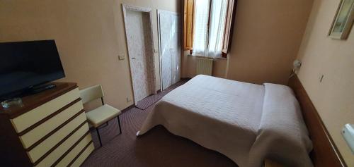 a bedroom with a bed and a flat screen tv at Hotel Giovanna in Montecatini Terme