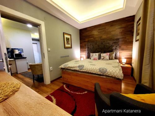 a bedroom with a large bed with a wooden headboard at Katanera 2 in Kraljevo