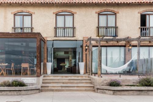 a store front of a building with glass windows at Hotel y Cabañas Campanario in La Serena