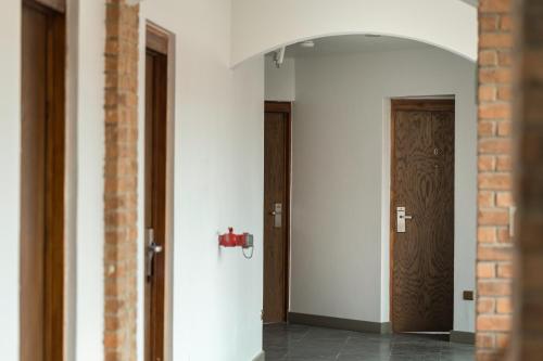 a hallway with two doors and a red fire hydrant at Hotel y Cabañas Campanario in La Serena