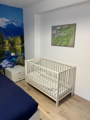 Postel nebo postele na pokoji v ubytování SUITE DOLOMITI Appartamento