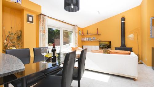 a dining room with a table and a fireplace at Atic Mar - Calella de Palafrugell in Calella de Palafrugell