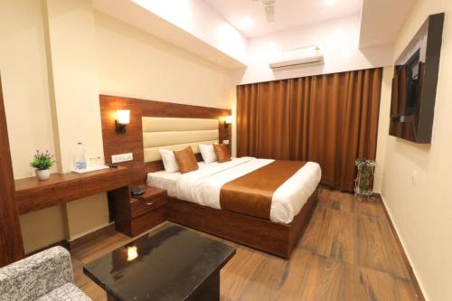 a hotel room with a bed and a television at Hotel BlueArk in Lucknow