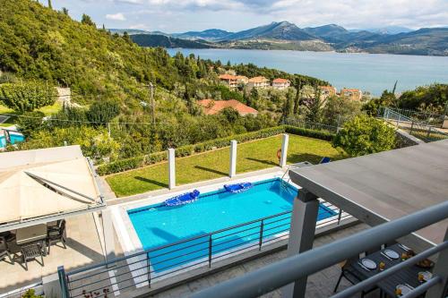 a swimming pool on the balcony of a house at Thealos Village aparthotel Lefkada in Lygia
