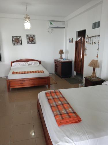 Una cama o camas en una habitación de Hospedaje Algarrobo Machalilla