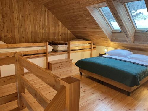a bedroom with a bed in a wooden cabin at Apartamenty Hucuł in Brenna