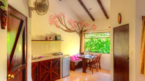 a kitchen with a table and a tree painted on the wall at Monte Terras in Tronadora