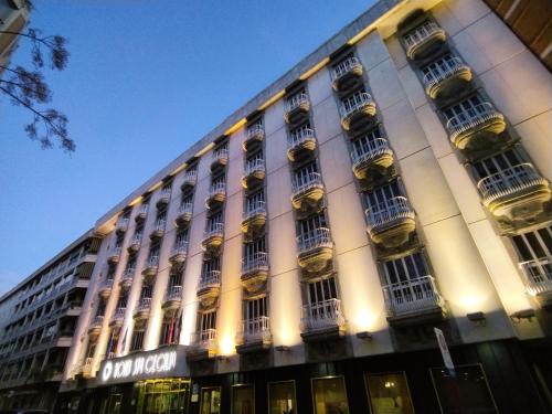 a large white building with a bunch of windows at Hotel Santa Cecilia in Ciudad Real