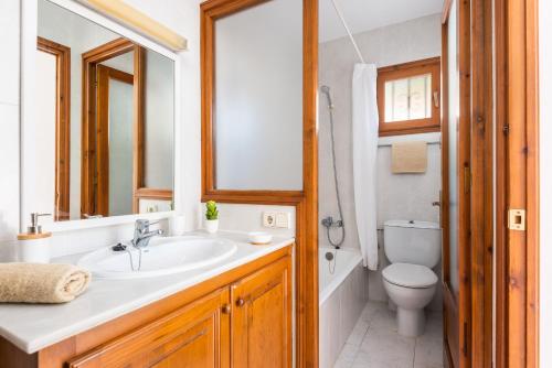 a bathroom with a sink and a toilet at Villa Vista Alegre - Cala Galdana in Ferreries
