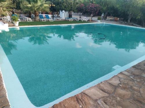 a swimming pool with turquoise water at Cortijo Torreblanca - 12 personas in Almería