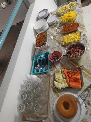 a table topped with lots of food on top at Pousada Maré Mansa in Maceió