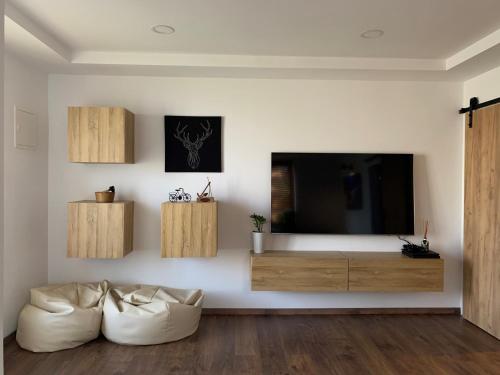 a living room with a tv and a couch at Apartment Bella Vista 1 in Izola