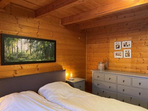 a bedroom with a bed and a tv on the wall at Haus Otis in Bad Mitterndorf