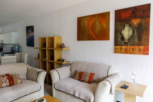 a living room with two couches and a table at Villas La Marina in Cancún