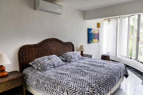 a bedroom with a bed with two pillows on it at Villas La Marina in Cancún