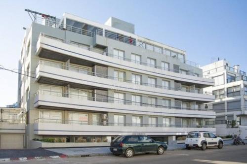 dos coches estacionados frente a un gran edificio en Moderno Apartamento en la Península, en Punta del Este