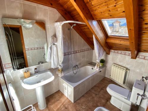 a bathroom with a tub and a sink and a toilet at Casa Torellola in Cardet