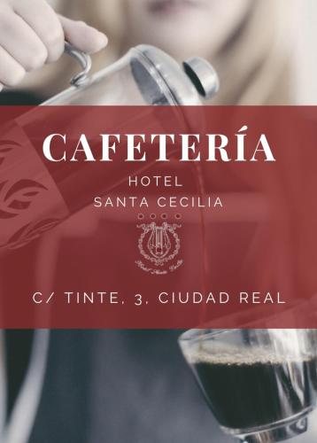a woman is pouring a glass of wine at Hotel Santa Cecilia in Ciudad Real
