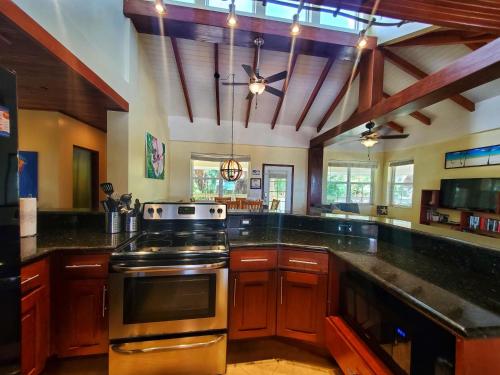 a kitchen with a stove and a counter top at Lucky Duck Villa - Private Beach Escape in Maya Beach