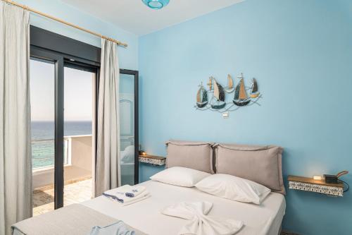 a bedroom with a bed with a view of the ocean at Villa Tania Samos in Samos