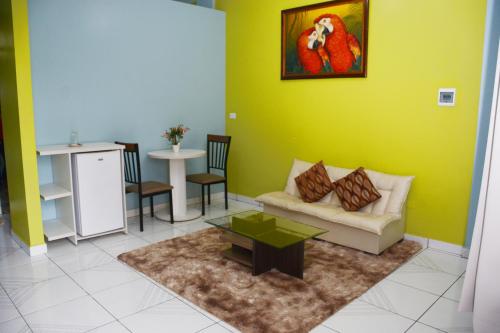 a living room with a couch and a table at Amazonia Hotel in Cobija