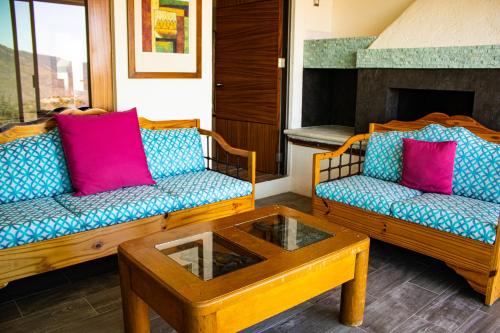 a living room with two couches and a coffee table at San Antonio Hotel Boutique in Santiago Matatlán