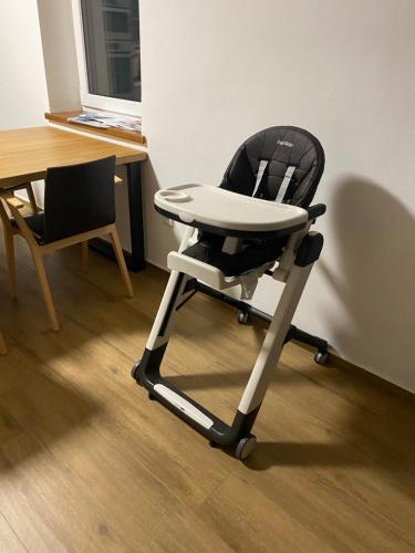 a black and white chair sitting in a room at Vila Kosmonautka - Velké Losiny in Velké Losiny