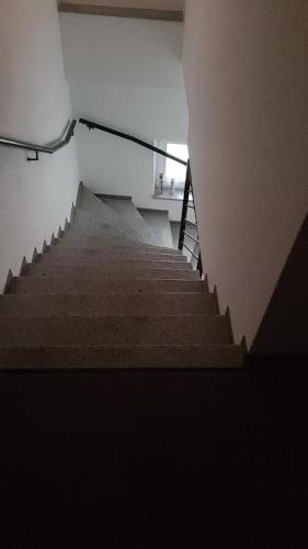 a staircase in a building with a person walking down it at Gästewohnung Kristall 3 in Salzwedel