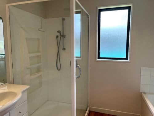 a bathroom with a shower and a sink at 51 St James Avenue in Hanmer Springs