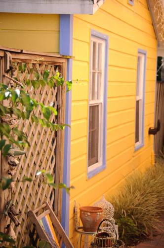 a yellow house with a door and a window at Old Colorado Inn in Stuart