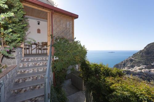 a house with a balcony with a view of the ocean at Casa Bianca in Positano