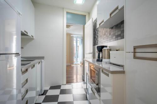 a kitchen with a black and white checkered floor at Minty Stay - Plaza Mayor 3 BD in Madrid