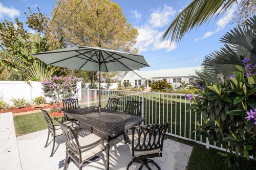 a black table with chairs and an umbrella at Old Colorado Inn in Stuart