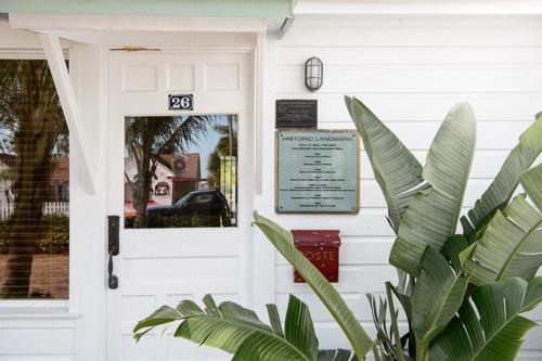 a white front door of a house with a sign on it at Old Colorado Inn in Stuart