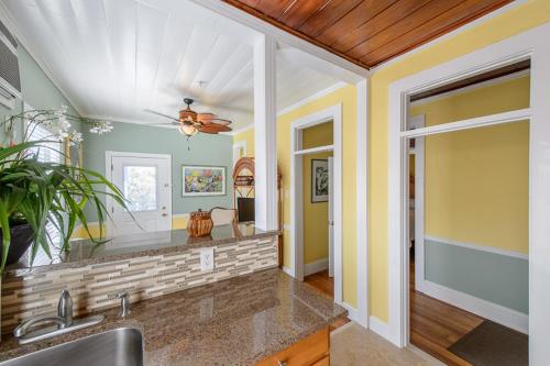 a kitchen with a sink and a ceiling fan at Old Colorado Inn in Stuart