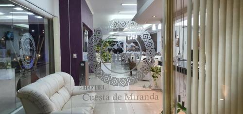 a store window with a white couch in a store at Hotel Cuesta de Miranda in Villa Unión