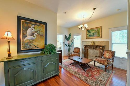 a living room with a large green dresser and a fireplace at Old Colorado Inn in Stuart