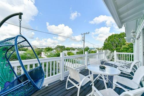 a porch with a swing and a table and chairs at Old Colorado Inn in Stuart