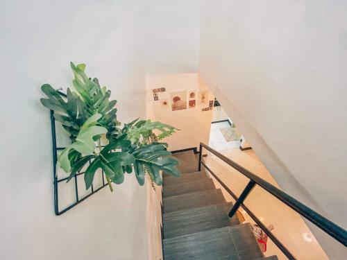 a staircase with a potted plant on the wall at Cozy Themed 2BR TownHouse - near Clark Airport - TRP1 in Angeles