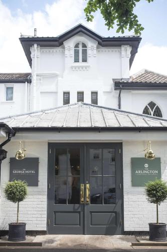 a white building with a door in front of it at George Hotel, BW Signature Collection in Norwich