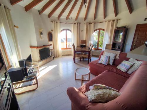 a living room with two couches and a fireplace at villa Anastasia in Cumbre del Sol