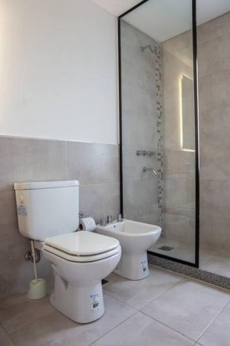 a bathroom with a toilet and a shower and a sink at Sweet Dreams I in Junín
