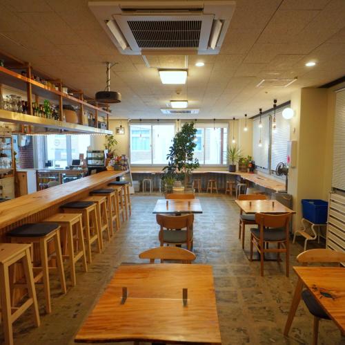 a restaurant with wooden tables and chairs and a bar at La Union in Fukushima