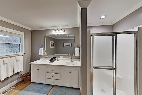 a bathroom with a sink and a shower at Brownstone Escape in Asheville