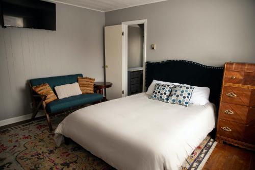 - une chambre avec un grand lit et une chaise dans l'établissement Charming French Studio Apartment, à Laramie