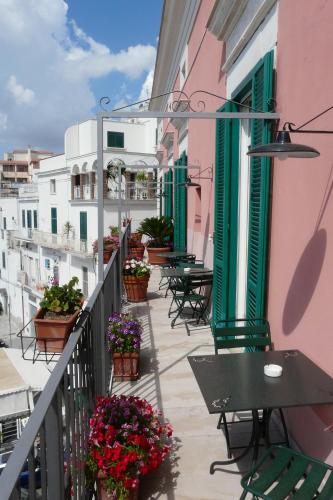 a balcony with tables and flowers on a building at La Dolce Vista - B&B di Charme in Manfredonia