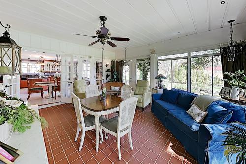 a living room with a blue couch and a table at Bella Rosa Country Estate in Goodlettsville